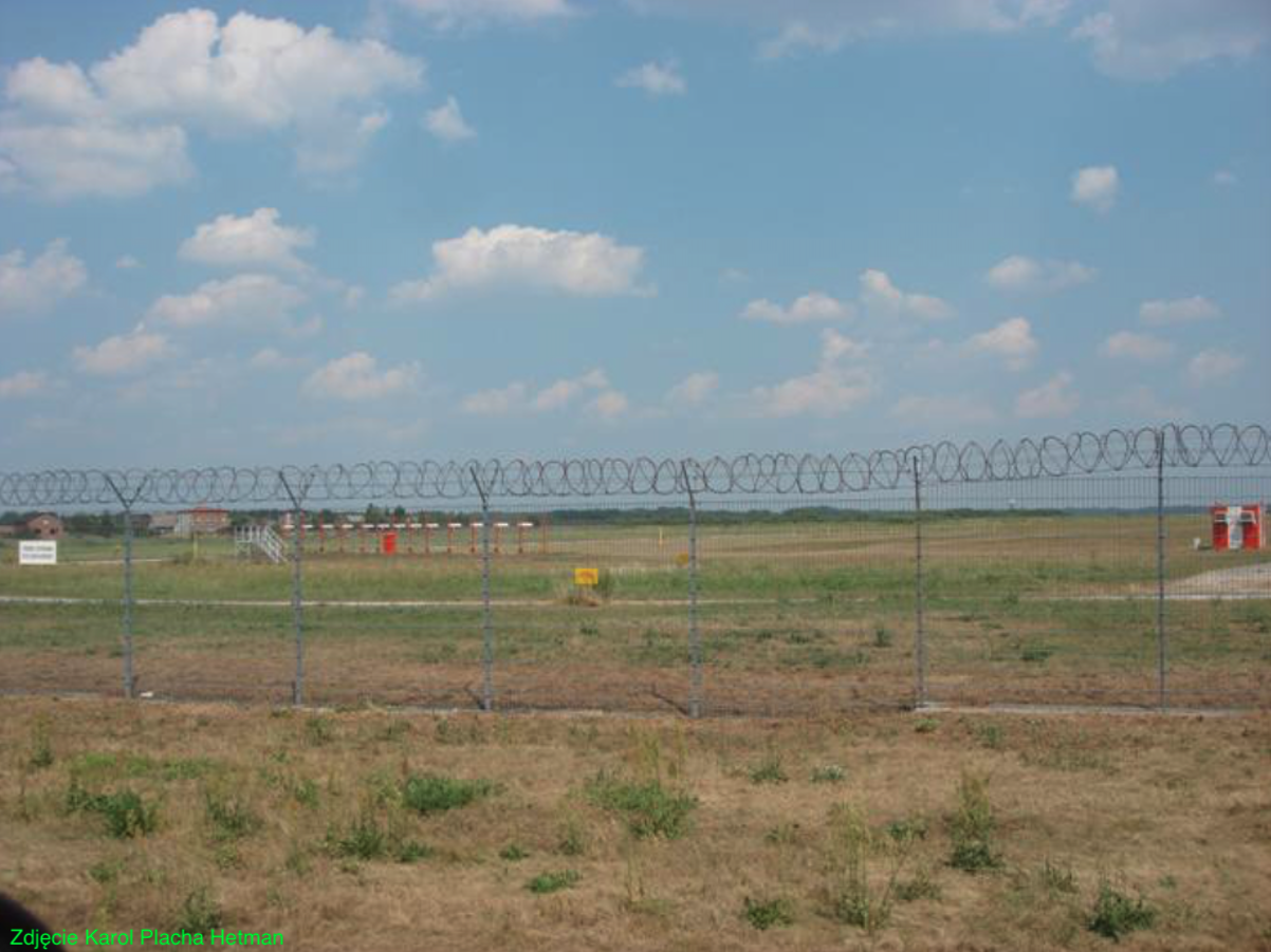 The airport fence from the west. ILS system antennas visible. 2010 year. Photo by Karol Placha Hetman