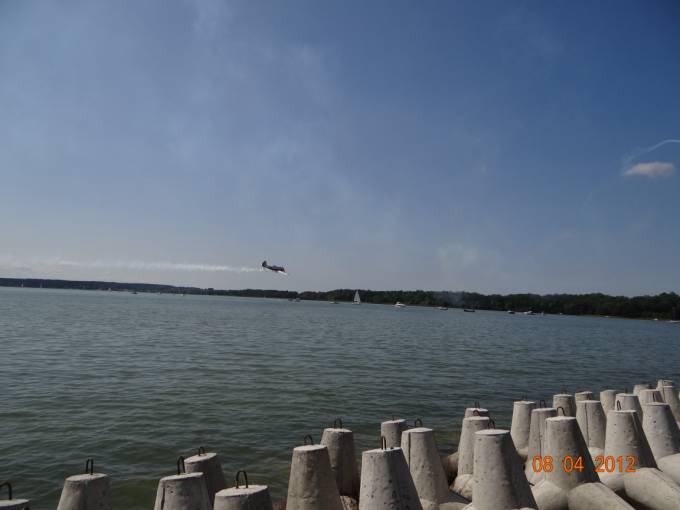 Low pass of the Yak-52 plane over Lake Niegocin. 2012 year. Photo by Karol Placha Hetman