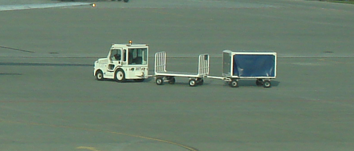 Luggage trolleys with a tug. 2009 year. Photo by Karol Placha Hetman